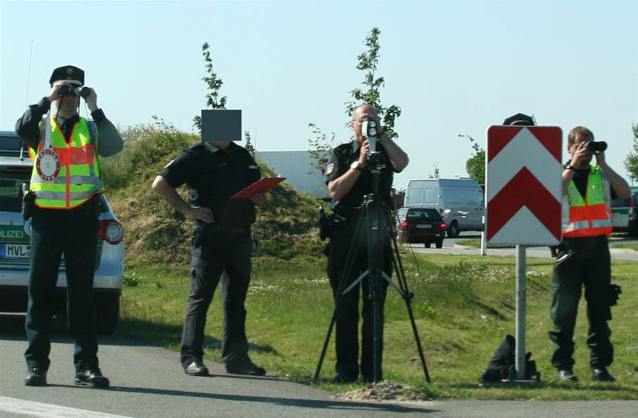Polizisten mit Ferngläsern und Laser Traffipatrol